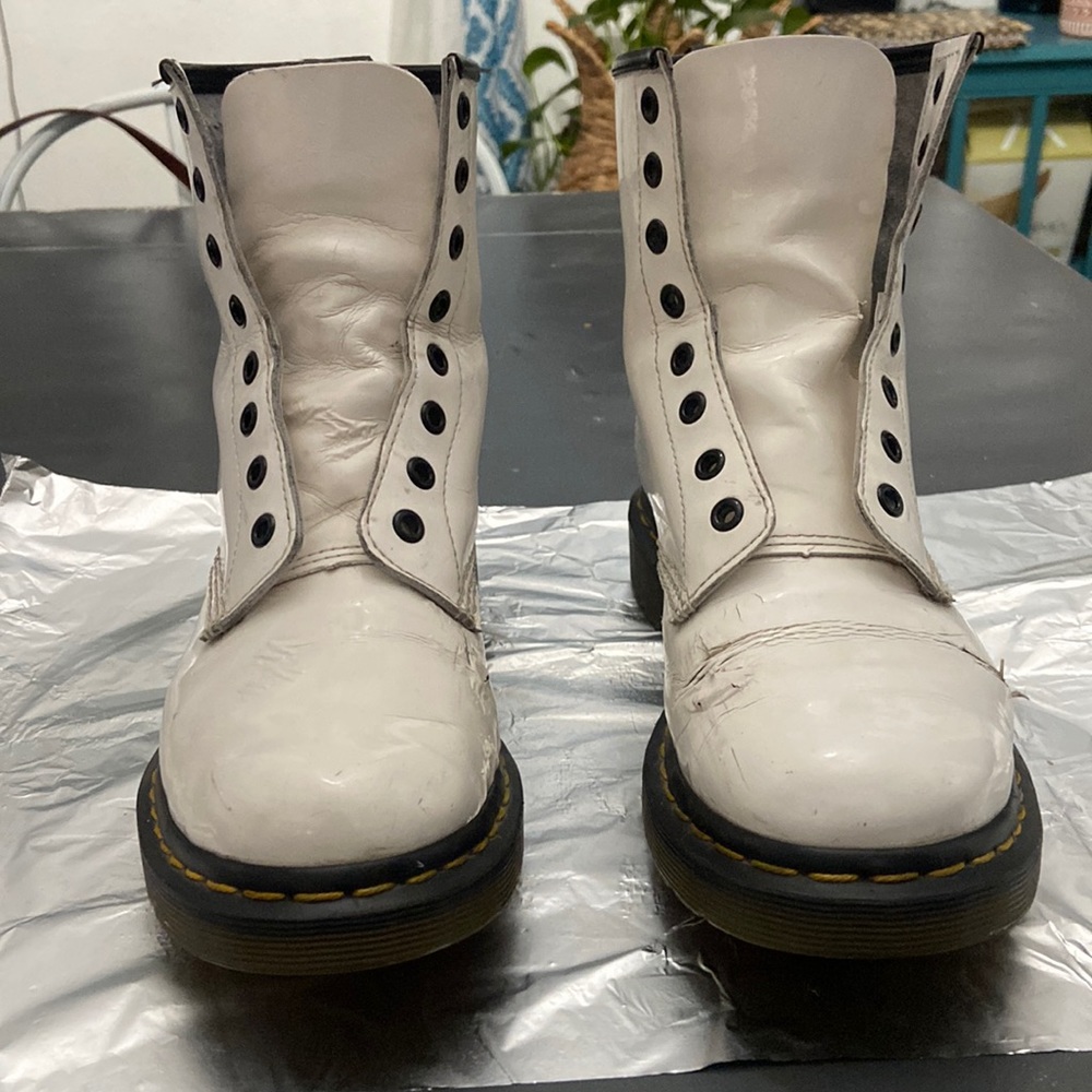 Damaged white Dr. martens with black laces